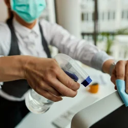 closeup-businesswoman-cleaning-her-computer-while-working-office